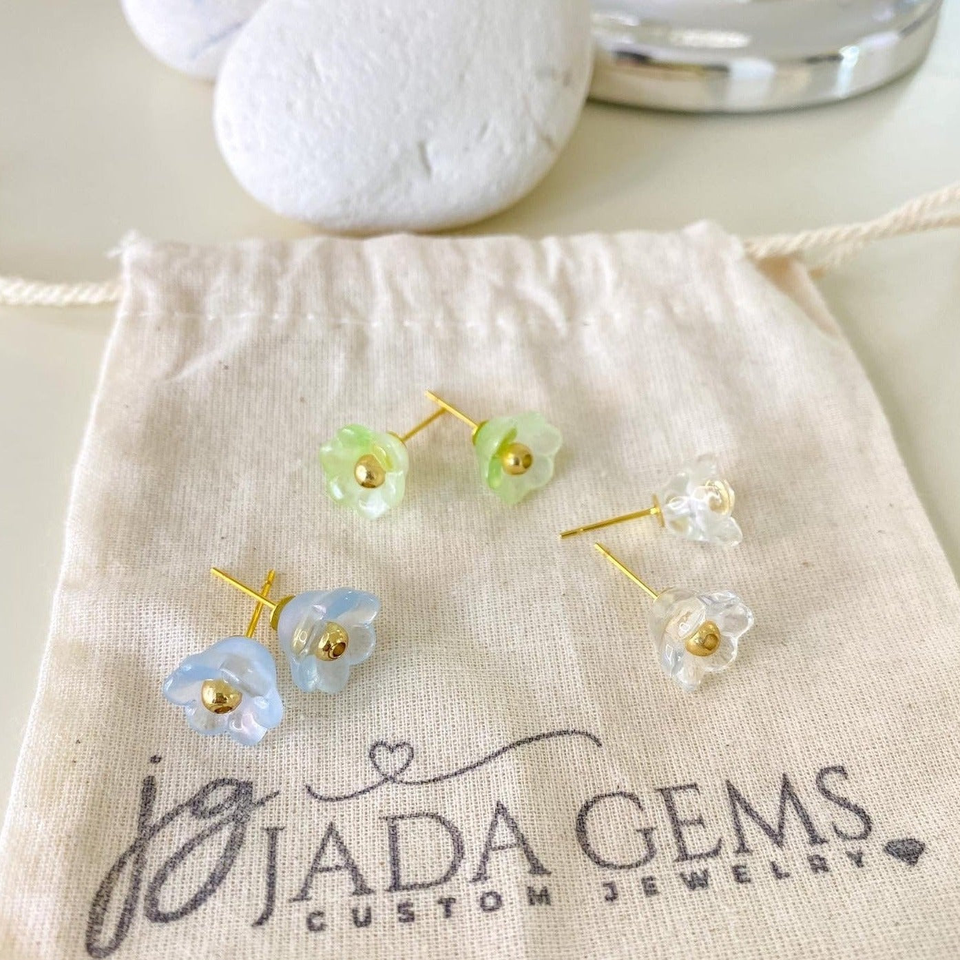flower stud earrings in green, blue and clear